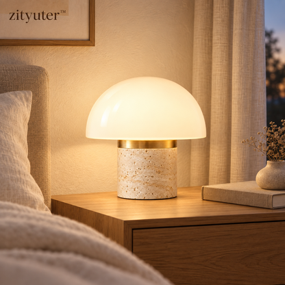 zityuter travertine dome lamp glowing on a bedroom nightstand